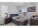 Cozy bedroom featuring colorful bed, side table, and view of exterior at 8550 Cheraw St, Littleton, CO 80125