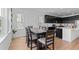 Dining room featuring modern chairs and table with a window view of the kitchen at 8550 Cheraw St, Littleton, CO 80125