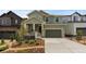 Inviting two-story home featuring a front porch and well-maintained landscaping at 8550 Cheraw St, Littleton, CO 80125
