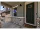 Inviting front porch with stone accents and a stylish front door at 8550 Cheraw St, Littleton, CO 80125