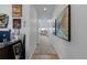 Hallway with modern decor leading into a light-filled living area at 8550 Cheraw St, Littleton, CO 80125
