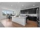 Modern kitchen features large island, stainless appliances, and adjacent dining area at 8550 Cheraw St, Littleton, CO 80125