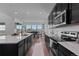 Modern kitchen featuring a large island, stainless appliances, and sleek countertops at 8550 Cheraw St, Littleton, CO 80125