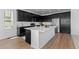 Bright kitchen with a large island, stainless steel appliances, and modern fixtures at 8550 Cheraw St, Littleton, CO 80125