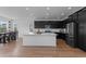 Modern kitchen with a large island, stainless steel appliances, and bright lighting at 8550 Cheraw St, Littleton, CO 80125