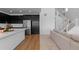 Stylish kitchen offering expansive island, stainless steel refrigerator, and access to staircase at 8550 Cheraw St, Littleton, CO 80125