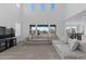 Bright living room features large sectional sofa and abundant natural light at 8550 Cheraw St, Littleton, CO 80125