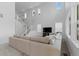 Open-concept living room with staircase, clock, and plentiful windows at 8550 Cheraw St, Littleton, CO 80125