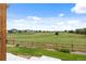 Picturesque view from the backyard overlooking a lush green field and neighboring homes at 11821 Joplin Ct, Commerce City, CO 80022