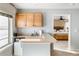 Basement kitchenette with cabinets and a small refrigerator at 11821 Joplin Ct, Commerce City, CO 80022