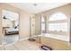 Bright bathroom with a bathtub, separate shower, tile floor, and view into the main bedroom at 11821 Joplin Ct, Commerce City, CO 80022