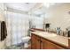 Bathroom with a shower curtain, toilet, and a vanity with light-colored wood cabinets at 11821 Joplin Ct, Commerce City, CO 80022