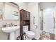 Well-maintained bathroom with a modern sink, storage cabinet, and glass-enclosed shower at 11821 Joplin Ct, Commerce City, CO 80022