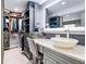 Luxurious walk-in closet featuring vanity with vessel sink and custom shelving for optimal storage at 11821 Joplin Ct, Commerce City, CO 80022