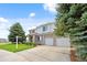 Spacious home with a manicured lawn, featuring a two-car garage and mature landscaping at 11821 Joplin Ct, Commerce City, CO 80022