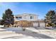 Two-story home with a snow-covered yard and a two-car garage at 11821 Joplin Ct, Commerce City, CO 80022