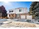 Winter view of a beautiful home with a brick facade, spacious driveway, and snowy yard at 11821 Joplin Ct, Commerce City, CO 80022
