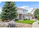 Attractive home with brick and siding, mature trees, landscaping, and a stone-lined garden at 11821 Joplin Ct, Commerce City, CO 80022