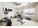 Home gym with large windows, carpeted floors, and workout equipment including a weight bench at 11821 Joplin Ct, Commerce City, CO 80022
