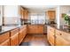 Spacious kitchen with light wood cabinets, granite countertops, and a large window at 11821 Joplin Ct, Commerce City, CO 80022