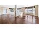 Spacious open-concept living area with hardwood floors and large windows for ample natural light at 11821 Joplin Ct, Commerce City, CO 80022