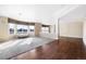 Open concept living room with hardwood floors, large windows, and neutral wall paint at 11821 Joplin Ct, Commerce City, CO 80022