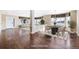 Spacious open-concept living and dining area with hardwood floors and large windows at 11821 Joplin Ct, Commerce City, CO 80022