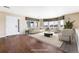 Bright living room with hardwood floors, large windows, and neutral decor at 11821 Joplin Ct, Commerce City, CO 80022