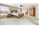 Spacious main bedroom with a ceiling fan, ensuite bath, and view of the outdoors at 11821 Joplin Ct, Commerce City, CO 80022