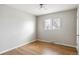 An interior shot of a bedroom with hardwood floors, grey paint, and a ceiling fan at 5141 S Grant St, Littleton, CO 80121