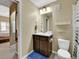 Light-filled bathroom with vanity, neutral walls and a blue bath mat at 1044 Rockhurst Dr # 202, Highlands Ranch, CO 80129