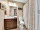 Well-lit bathroom featuring a single sink vanity, tiled floors, and neutral decor at 1044 Rockhurst Dr # 202, Highlands Ranch, CO 80129