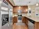 Modern kitchen with stainless steel appliances and granite countertops at 1044 Rockhurst Dr # 202, Highlands Ranch, CO 80129