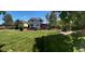 Extensive backyard with well-maintained lawn, solar panels, and a wooden deck for outdoor enjoyment at 4753 S Gar Way, Littleton, CO 80123