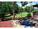 Secluded backyard featuring a tranquil water feature, lush greenery, and mature trees at 4753 S Gar Way, Littleton, CO 80123