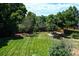 Expansive backyard with lush green grass, mature trees, and a serene, fenced-in area at 4753 S Gar Way, Littleton, CO 80123
