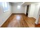 Spacious basement featuring gleaming hardwood floors, white walls, and a bright window at 4753 S Gar Way, Littleton, CO 80123