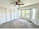 Bedroom with neutral carpet, sliding door closet, a ceiling fan, and bay window with lots of natural light at 4753 S Gar Way, Littleton, CO 80123