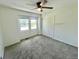 Bedroom with neutral carpet, a ceiling fan, closet with sliding doors and a window at 4753 S Gar Way, Littleton, CO 80123