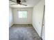 Simple bedroom featuring carpet, a window, and a closet with white doors at 4753 S Gar Way, Littleton, CO 80123