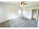 Bedroom with a ceiling fan, neutral carpet, and a closet with double doors, complemented by natural light at 4753 S Gar Way, Littleton, CO 80123
