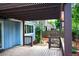 Covered wooden deck providing a cozy and stylish outdoor living space with privacy at 4753 S Gar Way, Littleton, CO 80123