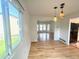 Open-concept dining room with hardwood floors, modern lighting, and natural light at 4753 S Gar Way, Littleton, CO 80123
