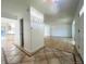 Open concept entryway featuring tile flooring and natural light, transitioning to hardwood floors in the spacious living area at 4753 S Gar Way, Littleton, CO 80123