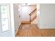 Inviting foyer with wood floors, staircase, and a view into the living area at 4753 S Gar Way, Littleton, CO 80123