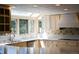 Sunlit kitchen featuring white countertops, stylish cabinetry, and stainless appliances at 4753 S Gar Way, Littleton, CO 80123