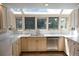 Bright kitchen with white countertops, cream cabinets, and stainless steel appliances at 4753 S Gar Way, Littleton, CO 80123