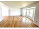 Bright living room with gleaming hardwood floors and a large bay window at 4753 S Gar Way, Littleton, CO 80123
