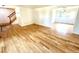 Spacious living room featuring hardwood floors and natural light from adjacent rooms at 4753 S Gar Way, Littleton, CO 80123