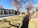 Large backyard featuring brick planters, a sun room addition, and a storage shed at 6556 Wolff St, Arvada, CO 80003